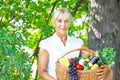 Mature woman holding basket with vegetables Royalty Free Stock Photo