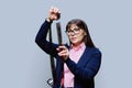 Woman holding photo negative film in hands, on gray background Royalty Free Stock Photo