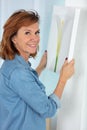 Mature woman at home holding painting Royalty Free Stock Photo