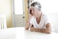 Mature woman at home touching her head with her hands while having a headache pain Royalty Free Stock Photo