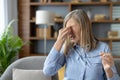 Senior woman feeling stressed with a headache at home Royalty Free Stock Photo