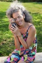 Mature woman hugging a small Teddy bear Garden