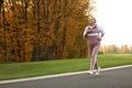 Mature woman jogging in park Royalty Free Stock Photo