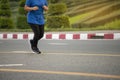 Mature woman jogging at park  in sunshine on beautiful summer day Royalty Free Stock Photo