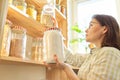 Mature woman in the kitchen pantry with products Royalty Free Stock Photo