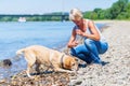 Mature woman with labrador riverside Royalty Free Stock Photo