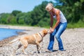 Mature woman with labrador riverside Royalty Free Stock Photo