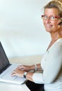 Mature woman, laptop and headset for call centre, company and remote work for telemarketing. Desk, internet and crm for Royalty Free Stock Photo