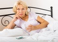 Mature woman laying with pills Royalty Free Stock Photo