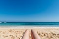 Mature woman legs sunbathing on the beach Royalty Free Stock Photo