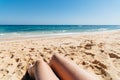 Mature woman legs sunbathing on the beach Royalty Free Stock Photo