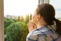 Mature woman looking out the window, close-up view from the back Royalty Free Stock Photo