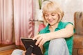 Mature woman looking at photo at home