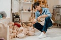 Mature woman looking at pottery handcrafts at the workshop Royalty Free Stock Photo