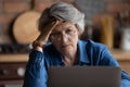 Mature woman feels confused experiencing difficulties with laptop usage Royalty Free Stock Photo