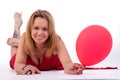 Mature woman lying, holding a ballon