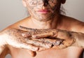 Mature woman making cosmetic mask