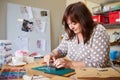 Mature Woman Making Jewelry At Home