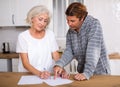 Mature woman and man doing paperwork together Royalty Free Stock Photo