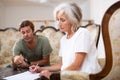 Mature woman and man doing paperwork together Royalty Free Stock Photo