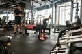 Mature couple working out in gym under trainer's controll Royalty Free Stock Photo