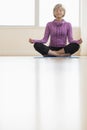 Mature Woman Meditating In Lotus Position