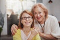 Mature woman meeting her senior mother at the coffee shop