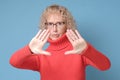 Mature woman moving away hands palms showing refusal and denial gesture