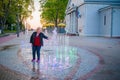 Mature woman near colorful fountain in resort