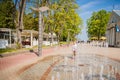 Mature woman near colorful fountain in resort