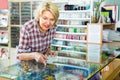 Mature woman near glass showcase in boutique Royalty Free Stock Photo