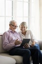 Mature woman and older father using modern tablet device Royalty Free Stock Photo