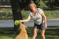 Mature woman playing with her dog. Royalty Free Stock Photo