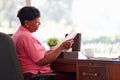 Mature Woman Putting Letter Into Keepsake Box Royalty Free Stock Photo