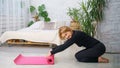 Mature woman reeling off Mat after training at home