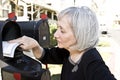 Mature woman retrieving mail Royalty Free Stock Photo