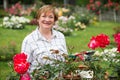 Mature woman roses garden