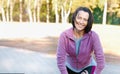 Mature woman runner taking a rest after running in the park Royalty Free Stock Photo