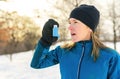 mature woman running at winter in park have some breathing diffi