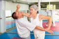 Woman self defense training gym learning to do painful grip Royalty Free Stock Photo