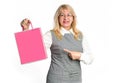 Mature woman shows her finger on the pink package. Royalty Free Stock Photo