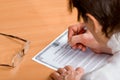 Mature woman signing Last Will Royalty Free Stock Photo