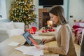 Woman Writing Christmas Cards At Home