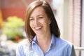 Mature Woman Smiling Outside On A Balcony Royalty Free Stock Photo