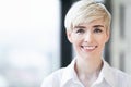 Mature Woman Smiling Standing Against Window Indoors, Portrait Royalty Free Stock Photo