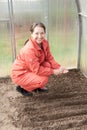 Mature woman sows seeds