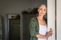 Mature woman standing at door Royalty Free Stock Photo