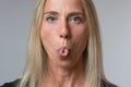 Mature woman sticking out her tongue at camera Royalty Free Stock Photo