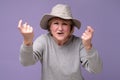 Mature woman in summer hat standing and looking at camera and screaming. Royalty Free Stock Photo