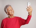 Mature woman taking a selfie with smartphone Royalty Free Stock Photo